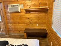 Clothes rack and bench in master bedroom.