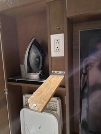 Ironing cupboard with the outlet flap open