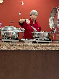 Staff never wore gloves but continued to refill the food, fold the boxes and put them in the garbage then immediately returned to refill more food never wore gloves never washed her hands