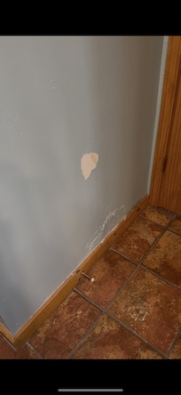 Wall behind master bathroom door to living room