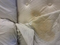 Mattress and pad or sheet in between mattress and top sheet. Clearly soaking up from mattress