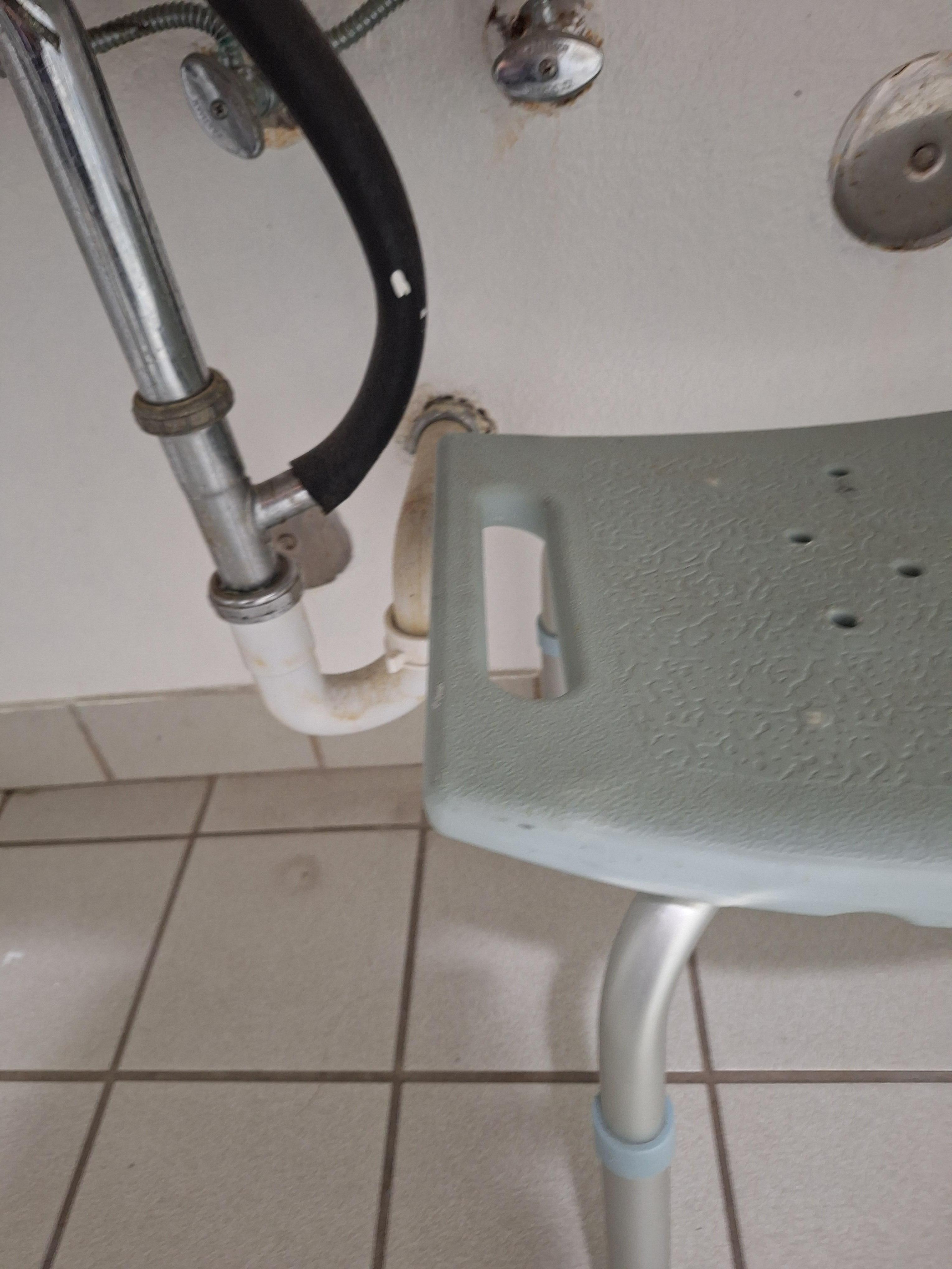 This is supposedly what makes this an assist suite.  A rickety dirty seat under the dirty sink, that you put into the tub and then step into.  Yeah, not ADA correct.