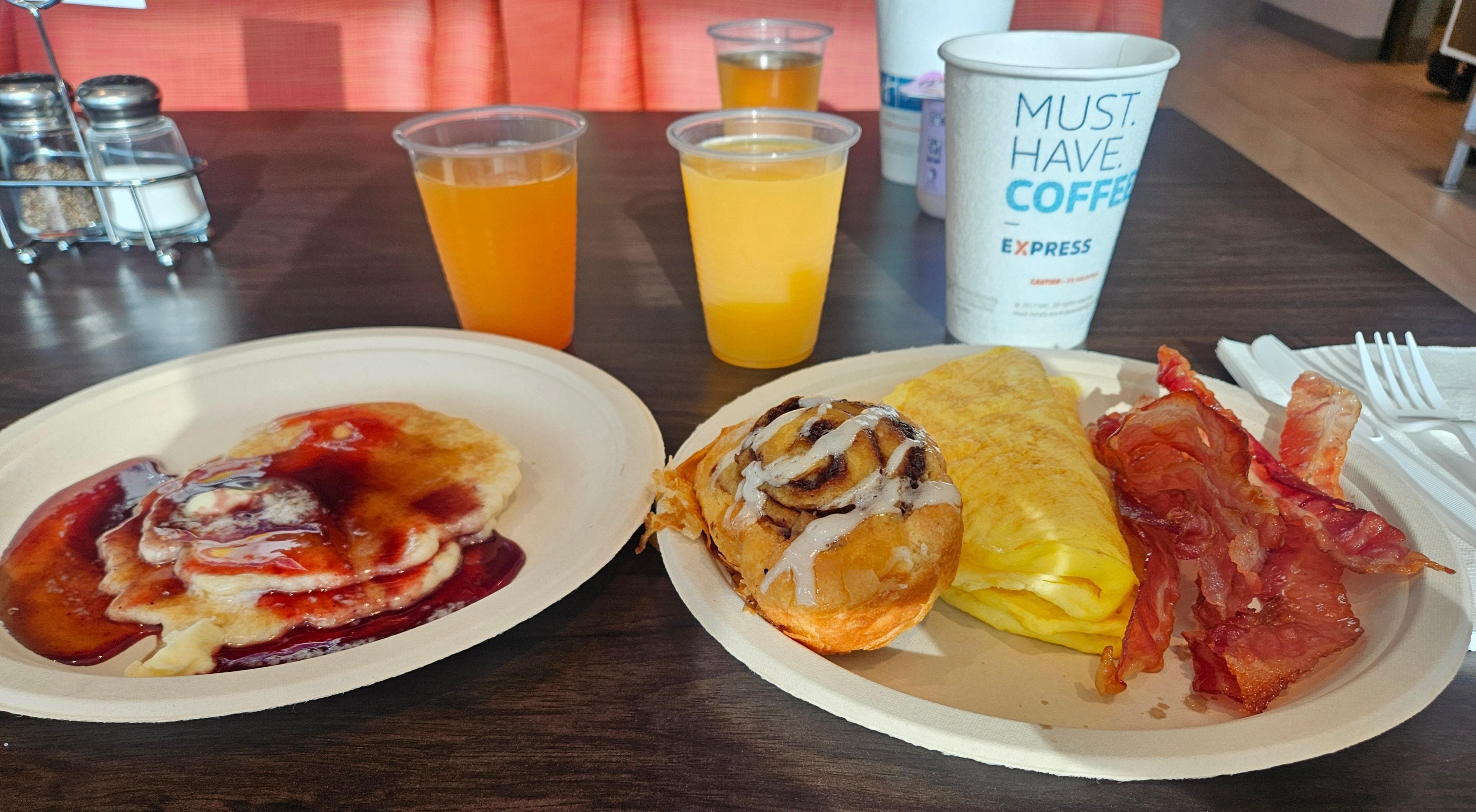 Free breakfast. Juice, coffee, cheese omelet, bacon, cinnamon roll, and pancakes. Plus many other selections I did not try.
