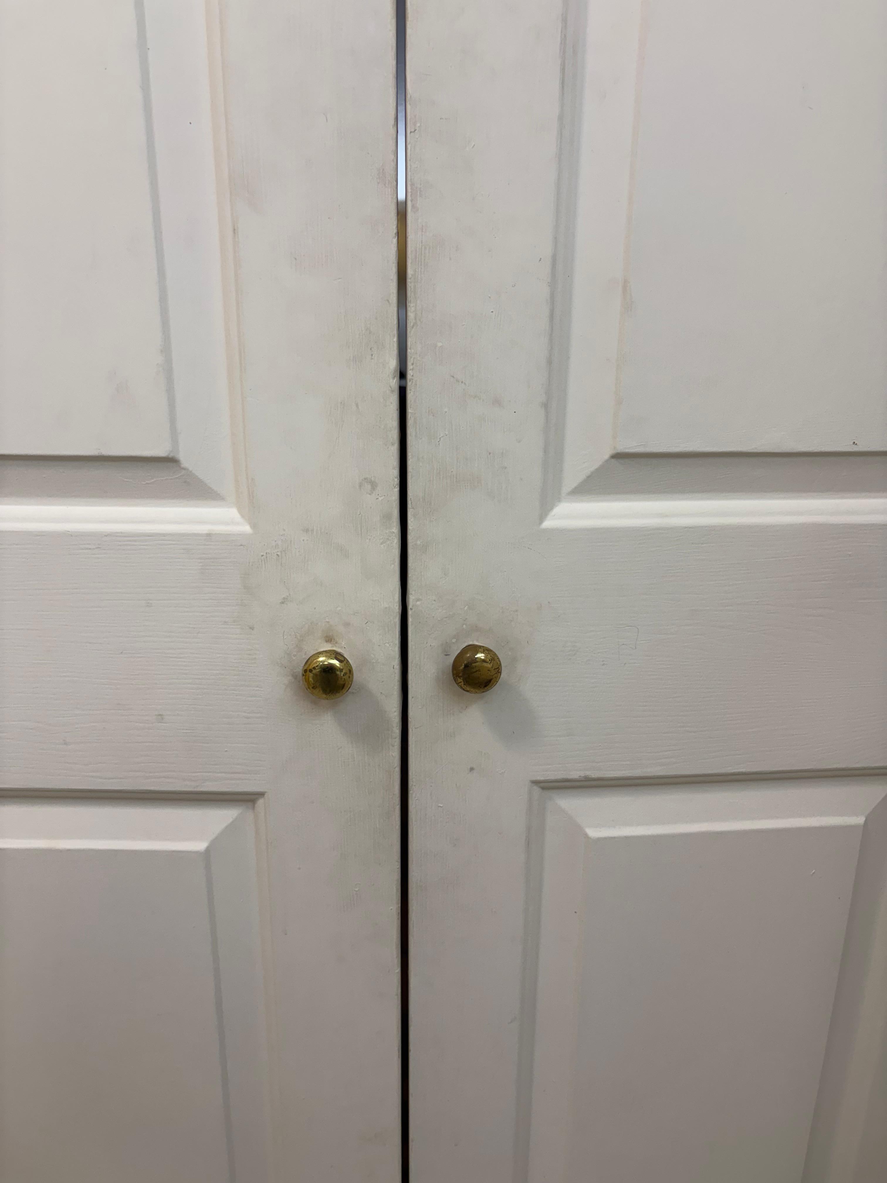 One side of dirt covered bathroom doors