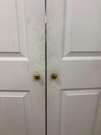 One side of dirt covered bathroom doors