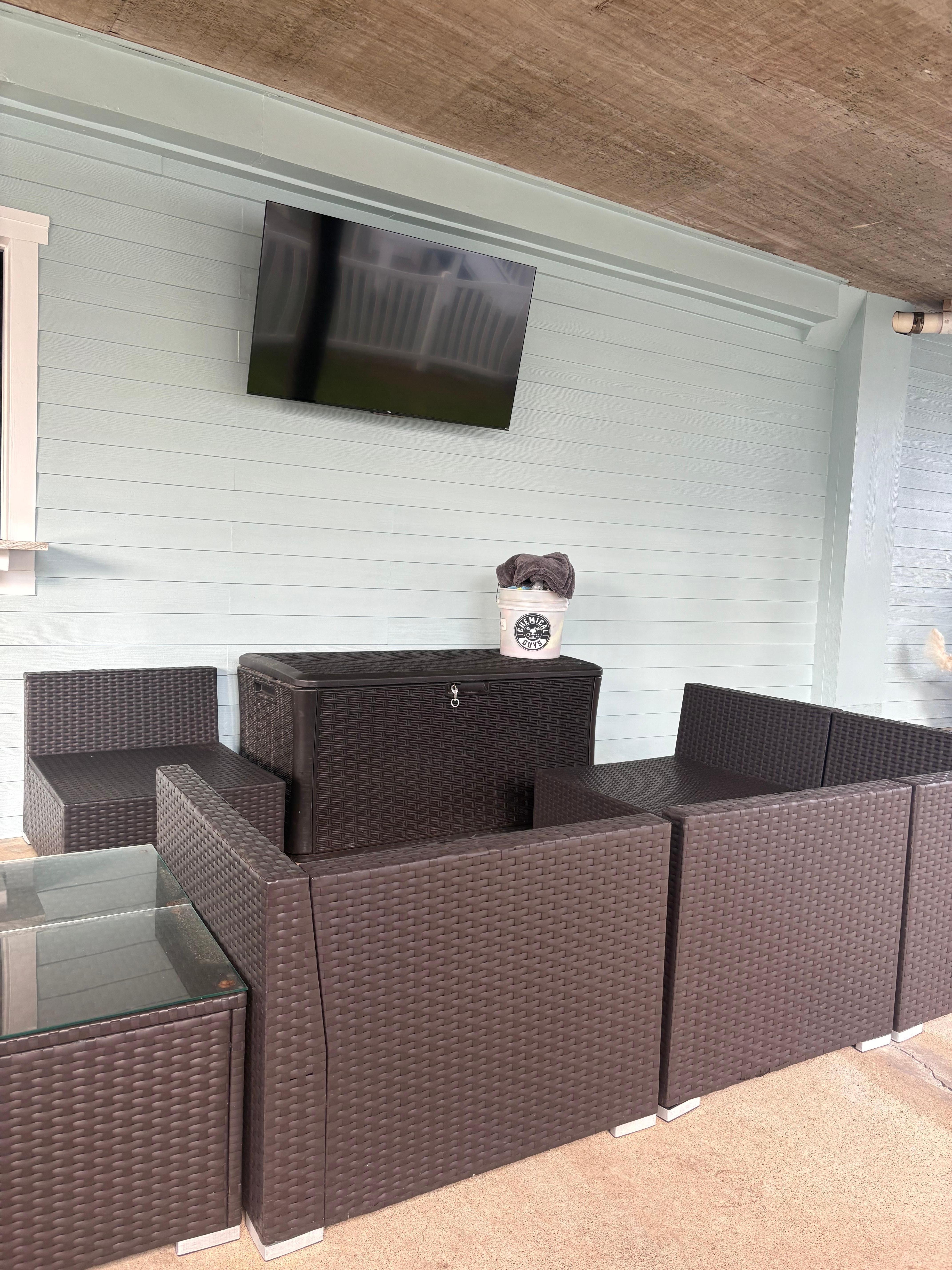 Nice seating around TV with cushions in cabinet