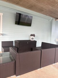 Nice seating around TV with cushions in cabinet