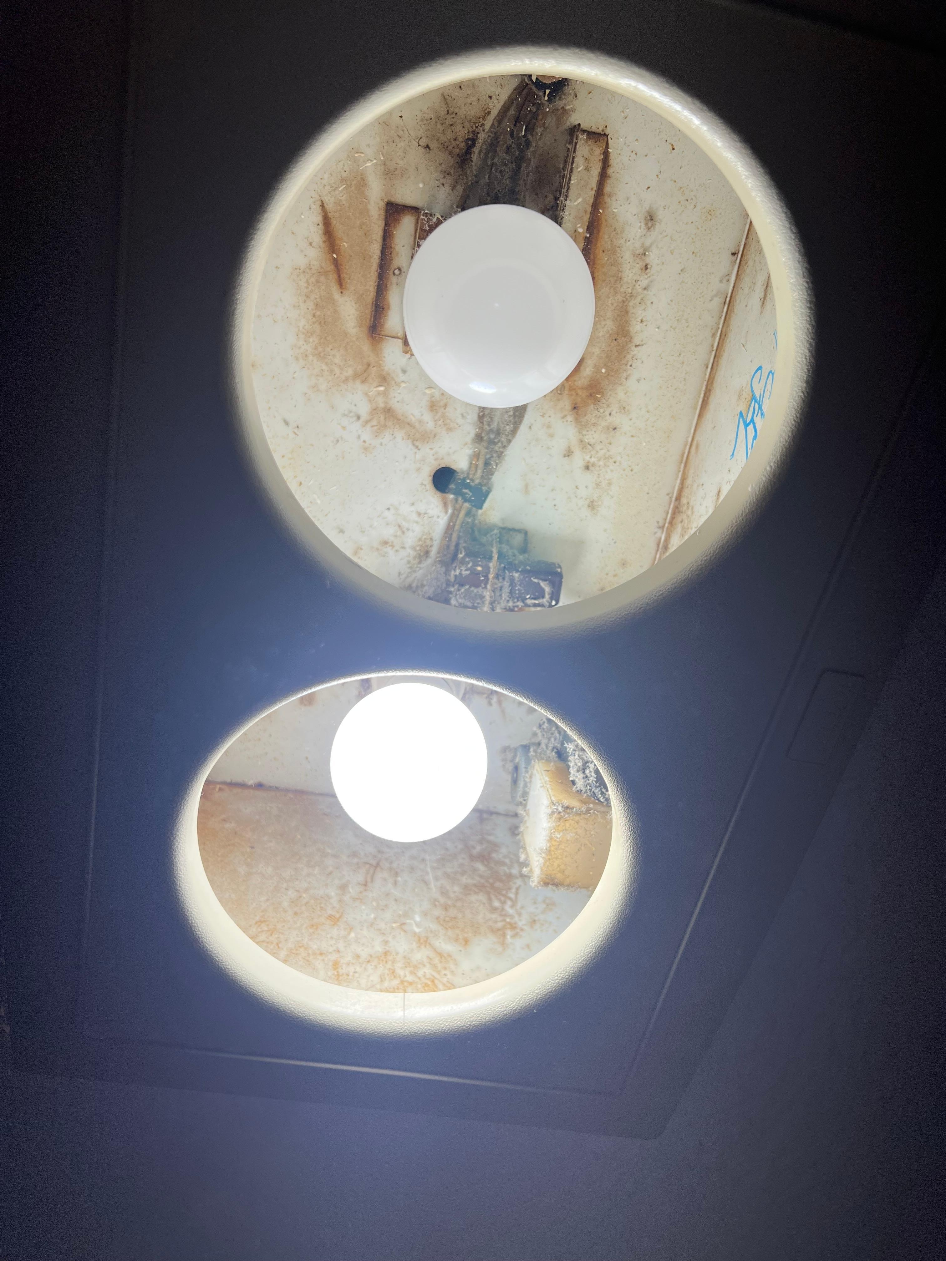 Bathroom light fixture missing cover. Can plainly see all the dust and mold.
