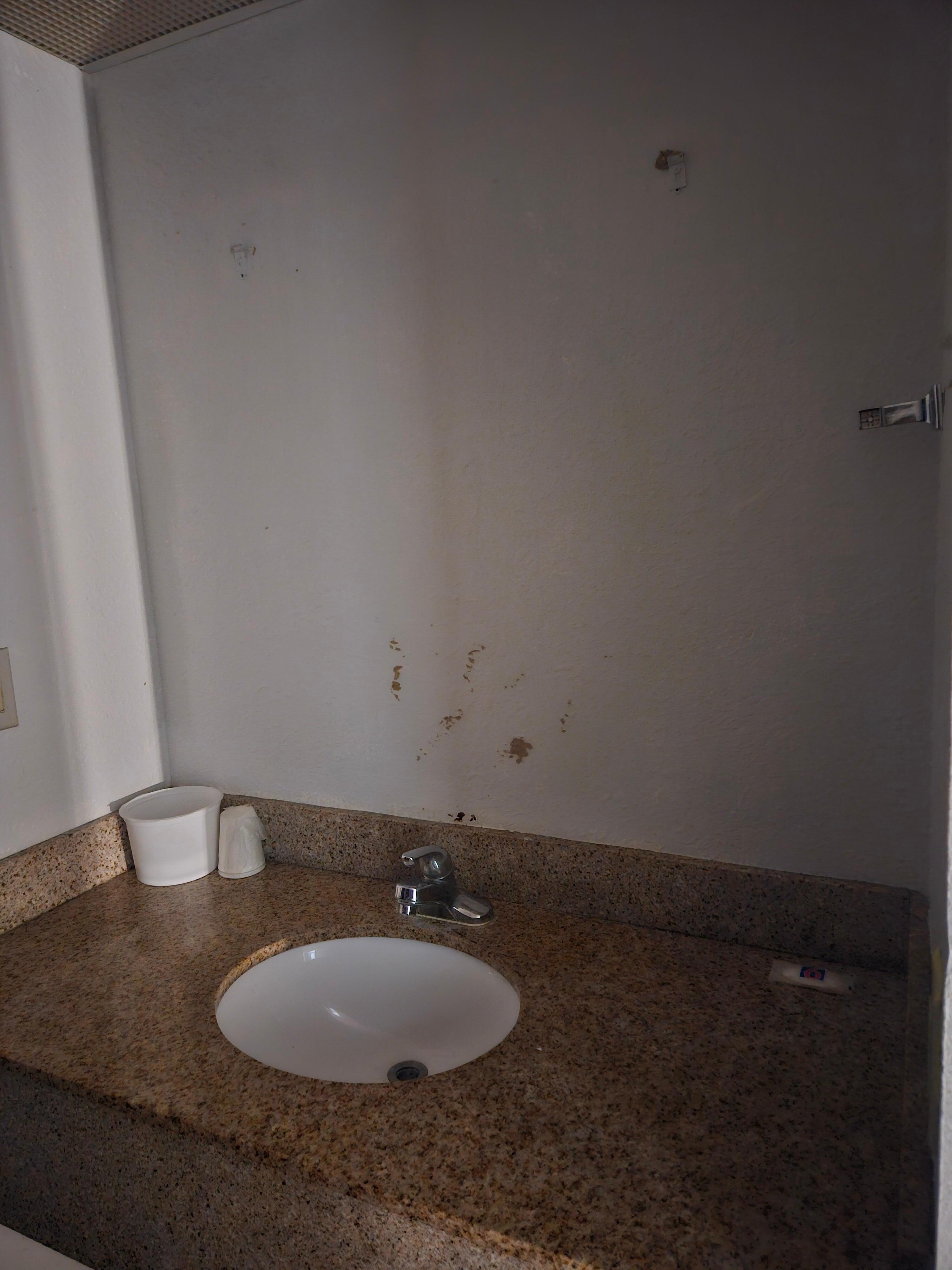 Towel holder missing on the side of the wall.  