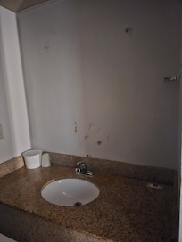 Towel holder missing on the side of the wall.