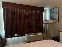 Window drapes add a wonderful touch of class to the room.