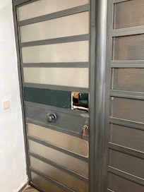 Whole in access door to the apartment making it insecure