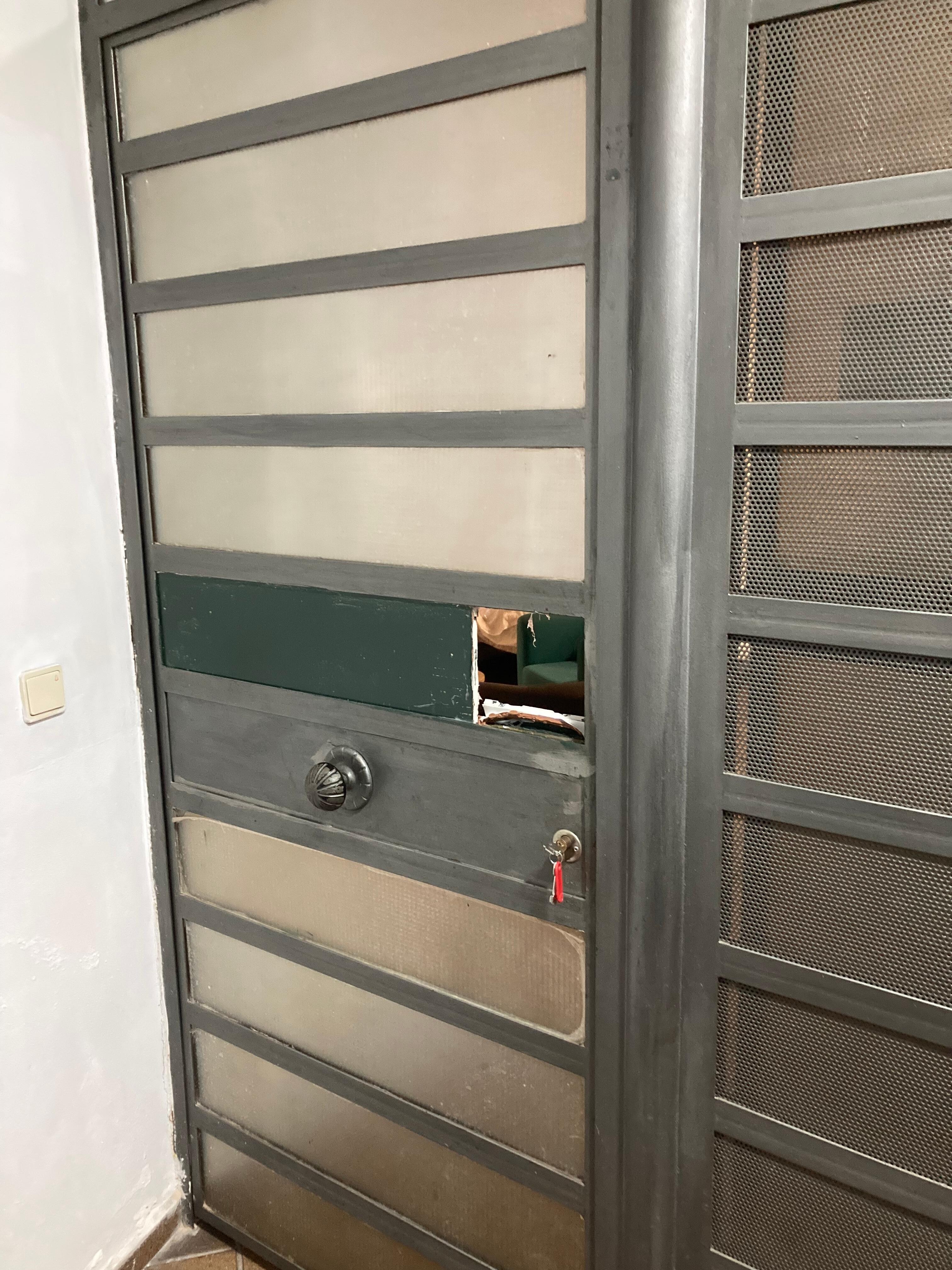 Whole in access door to the apartment making it insecure