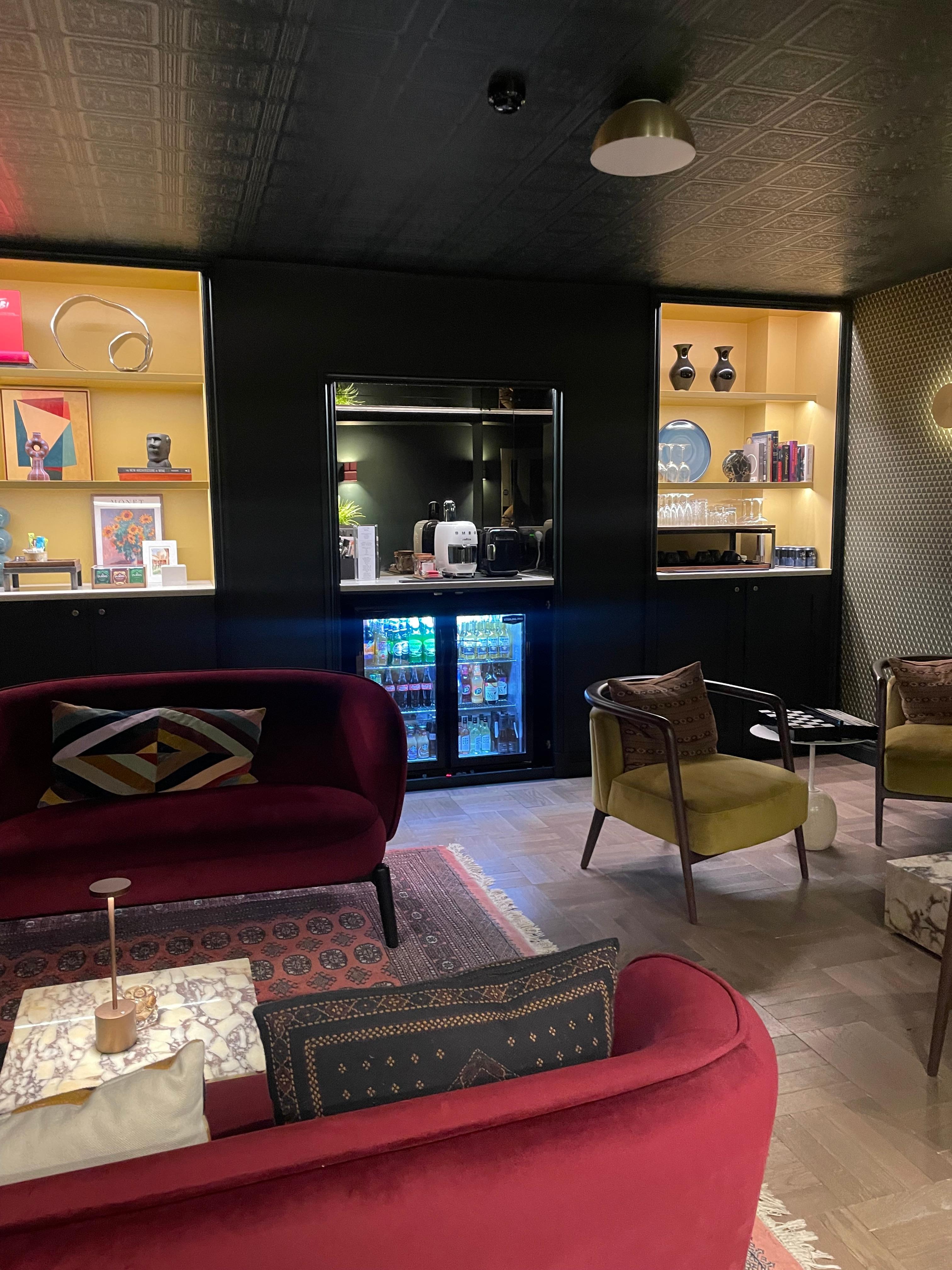 Adorable + chic bar/lounge area stocked with coffee, drinks & games - heaven. 