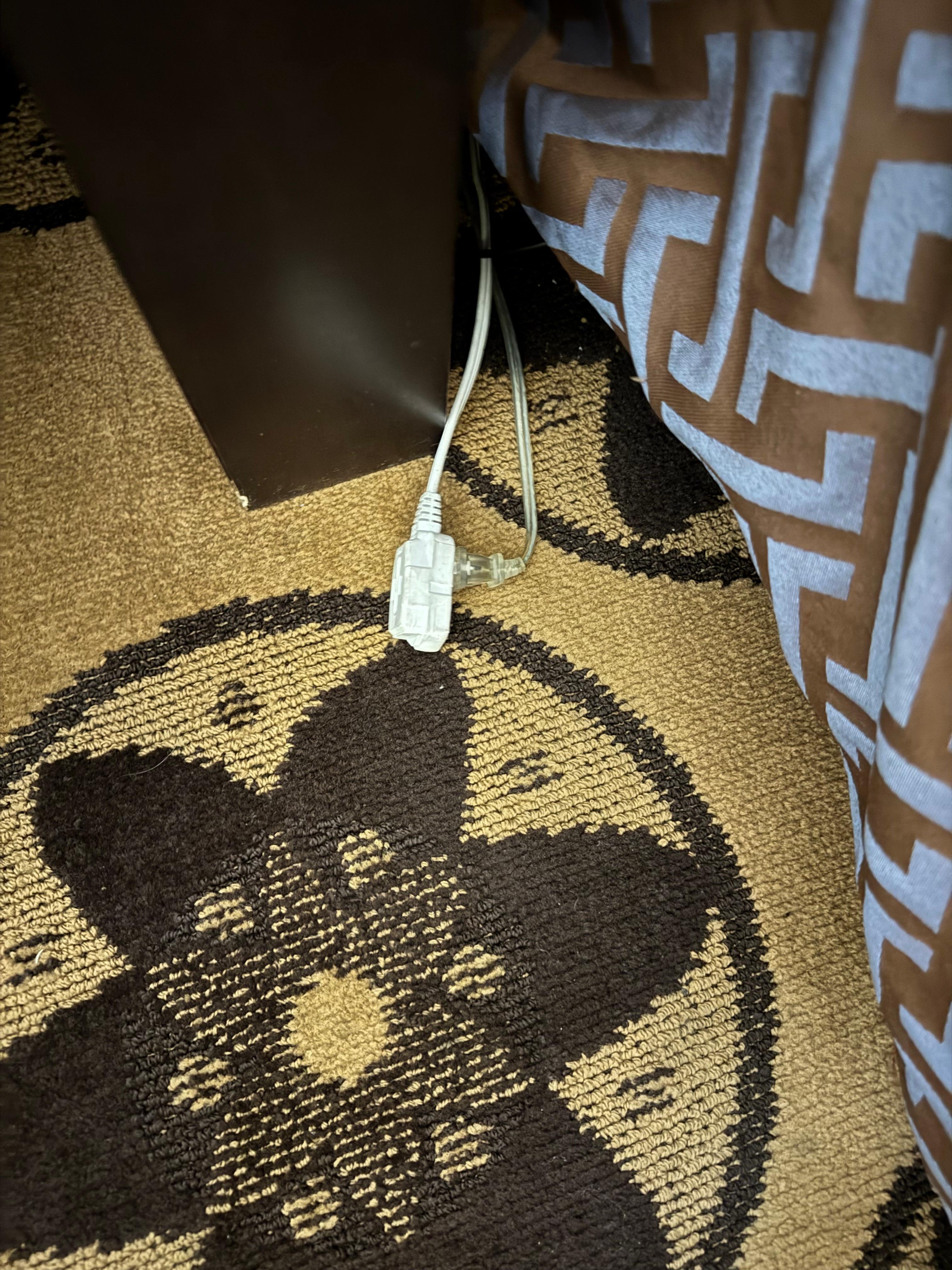 Extension cords on side of bed
