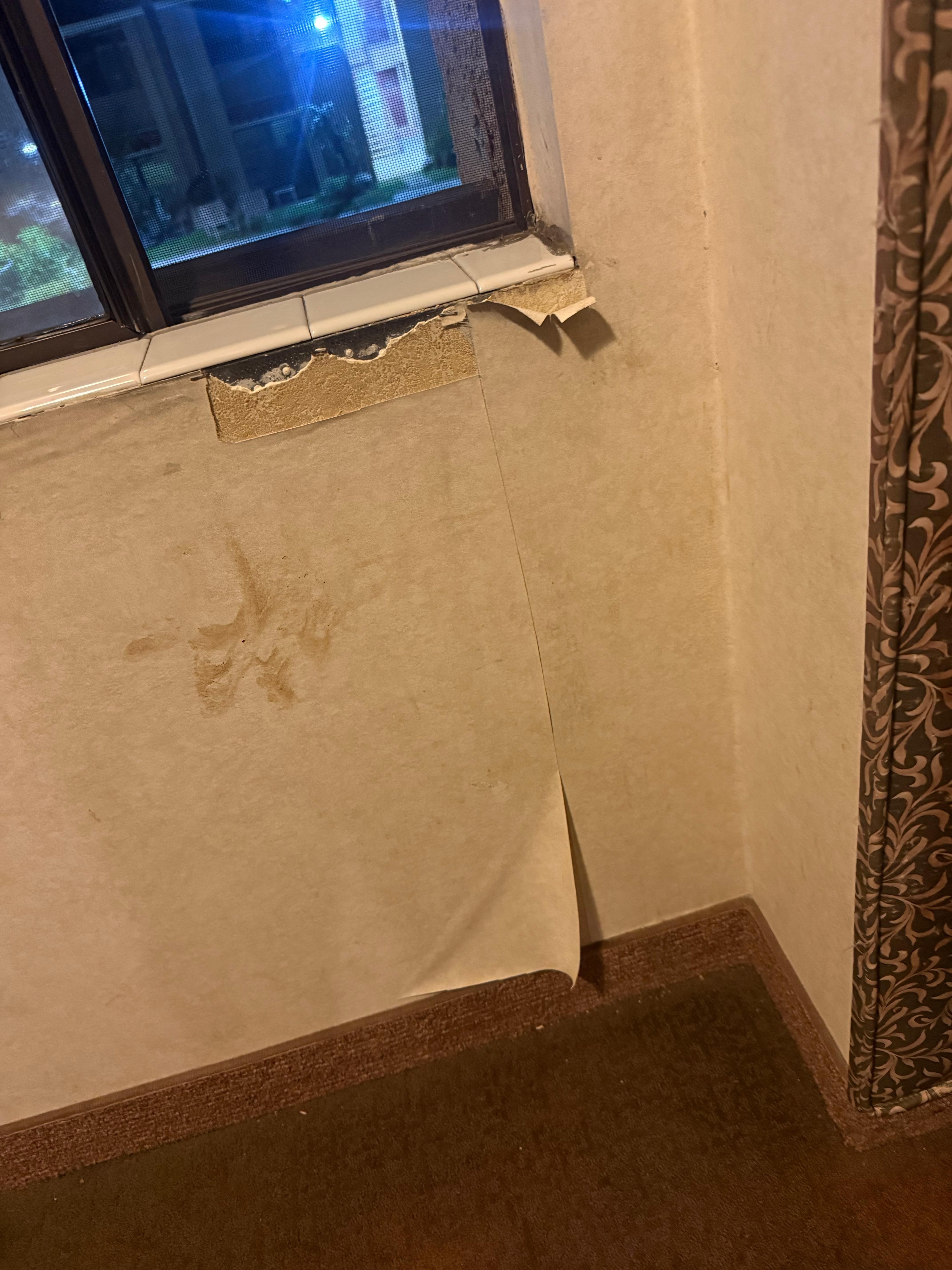 Water damage and wallpaper peeling off