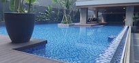 Swimming pool is very shaded and partly covered on one side.