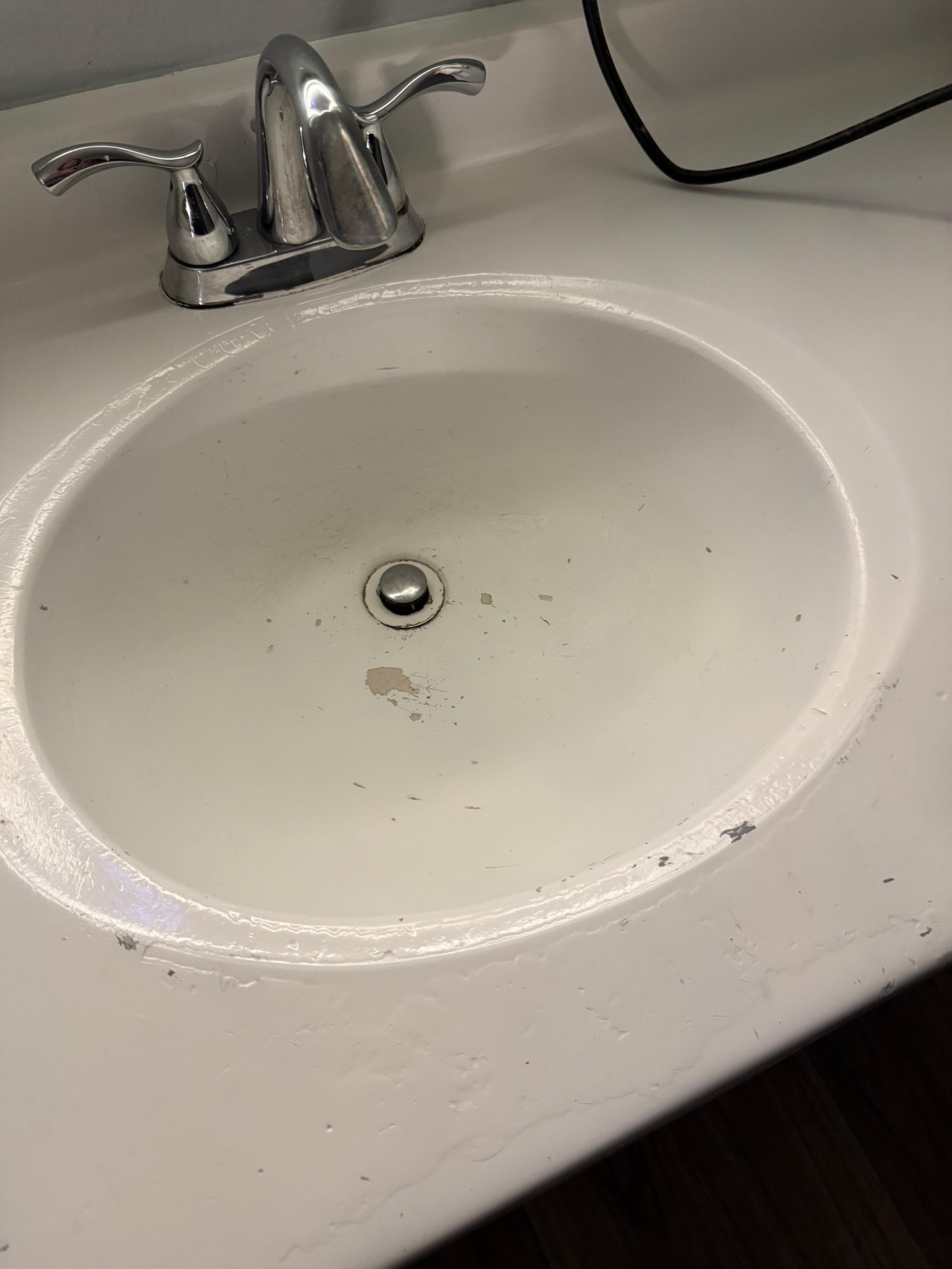 Sink crusted with paint and rust 