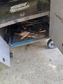 Grill dirty, trash underneath. Lack of basic cleaning.