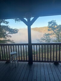 Early morning sunrise with fog lifting over river