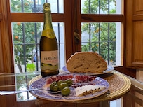 The dining room looks out over a patio with orange trees.