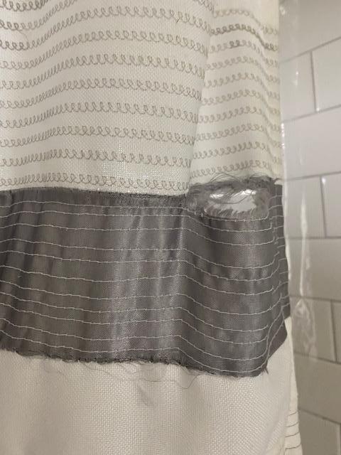 Torn shower curtain