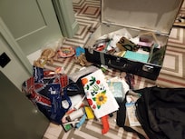 The suitcase had its lock broken, was opened, ransacked, and had water poured over it.-2