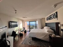 lack of design in overall room with 1 piece of art at ceiling, huge electric fireplace, no lounge chair, bad finishes