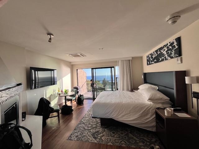 lack of design in overall room with 1 piece of art at ceiling, huge electric fireplace, no lounge chair, bad finishes