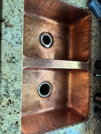 Copper sink that doesn't appear to have every been propertly cleaned.