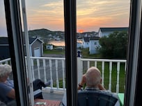 Family enjoys sunset from back deck.
