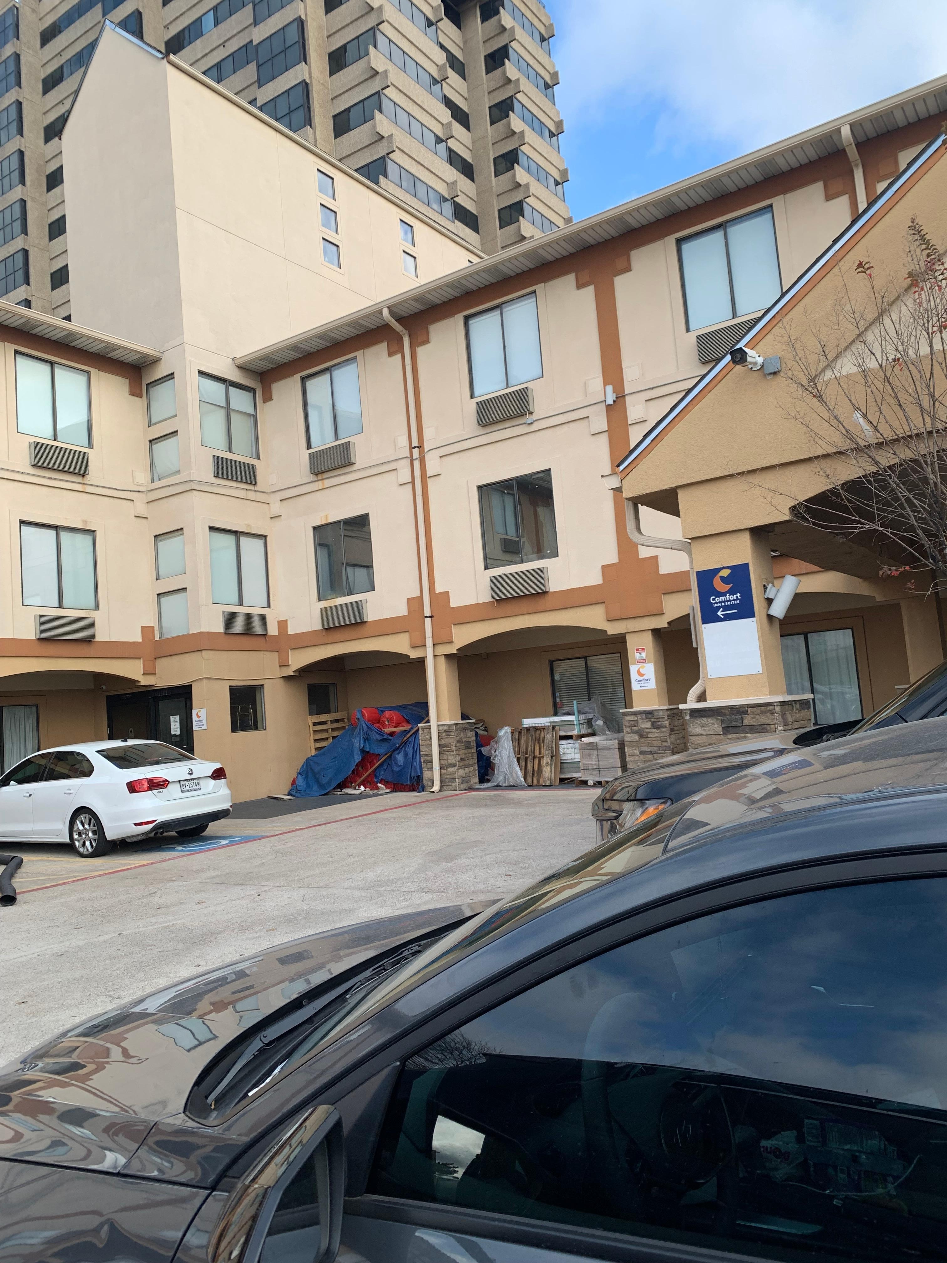 Piles of trash, carpet, dust at the entrance