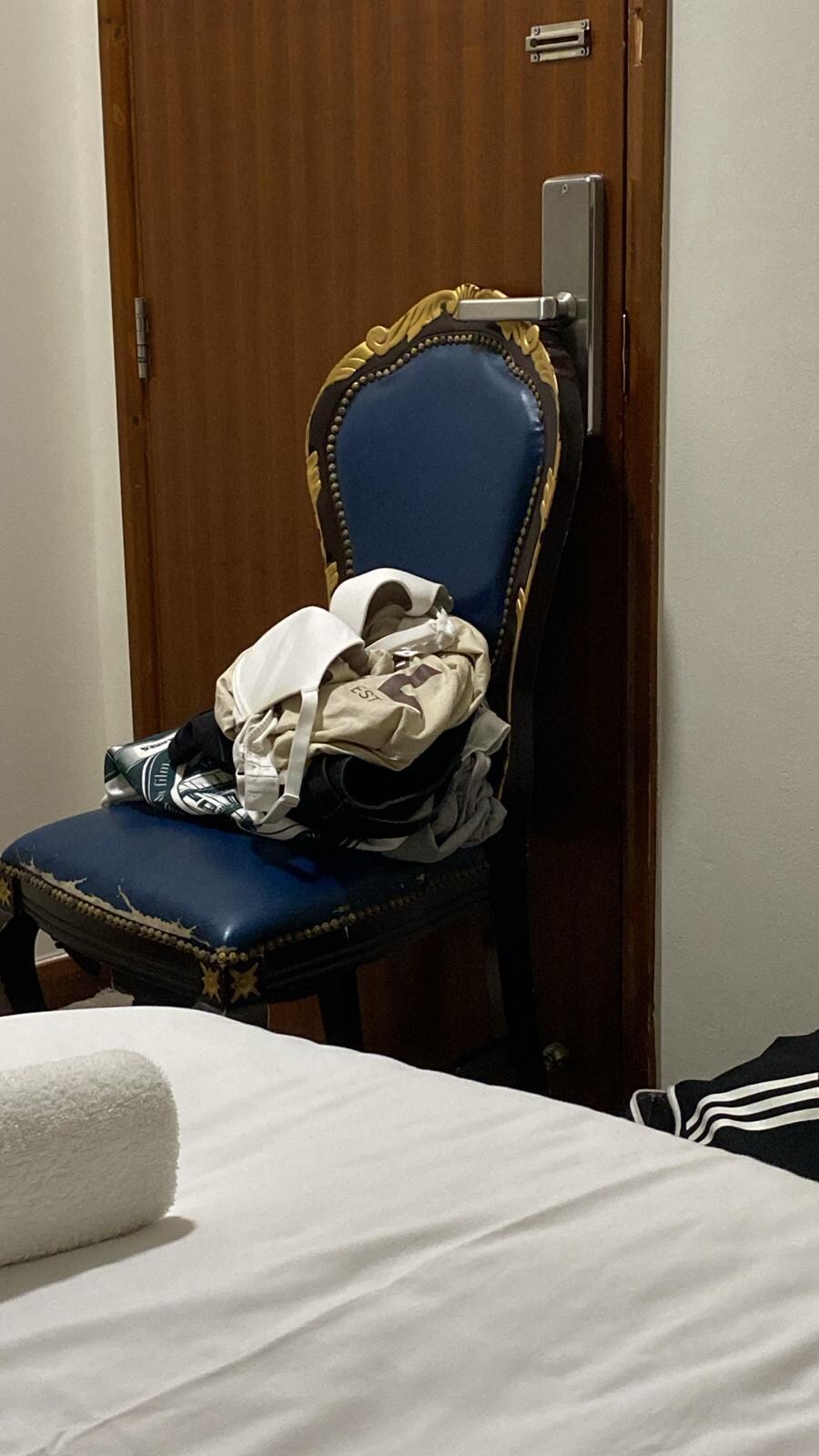 Son and girlfriend felt so uncomfortable with all the men hanging around the hotel they felt the need to use the chair to block the door 