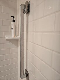 Safety hazard, the hand rail in the shower is protruding from the wall.. scraped my shoulder even while being careful, do to it being placed under shower head.