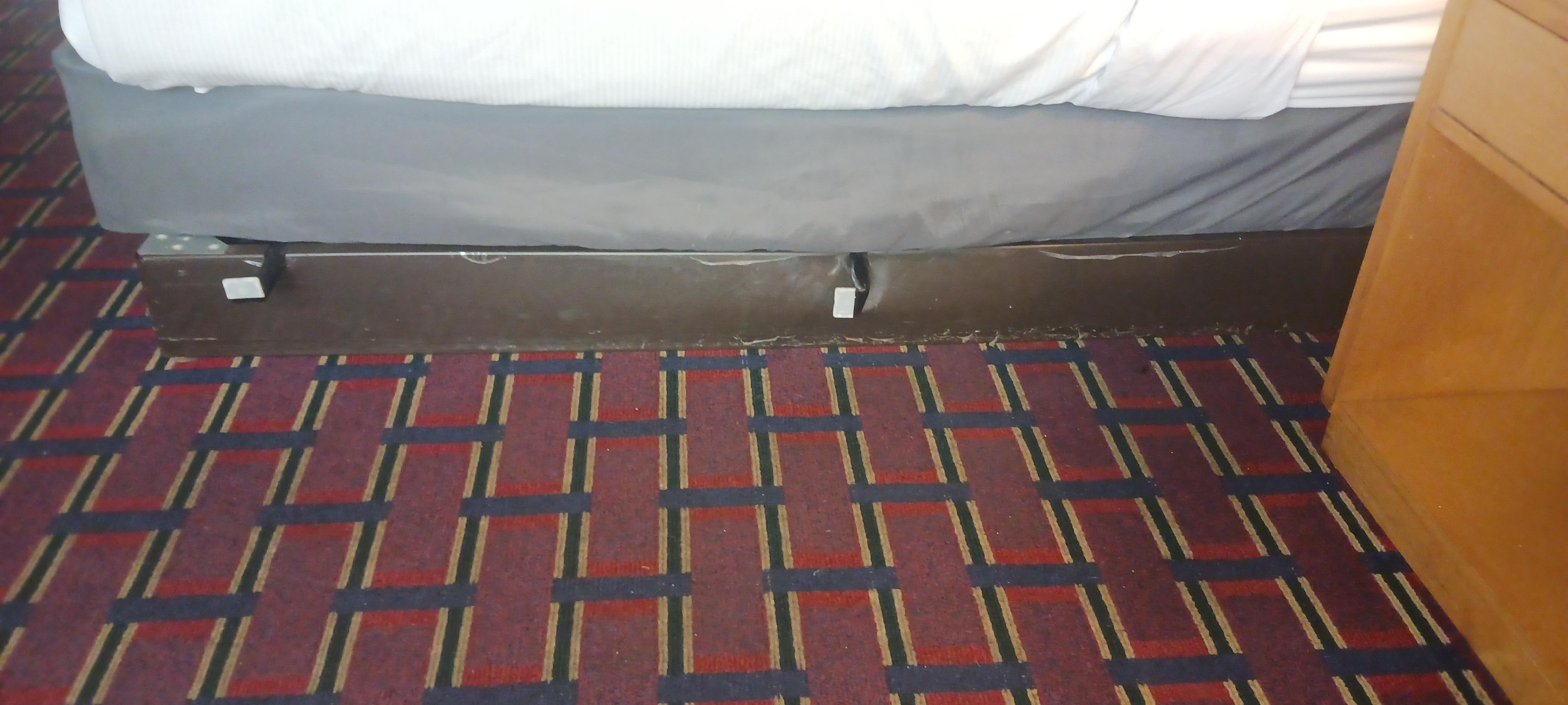 Picture of the bed frame sticking out from the mattress 