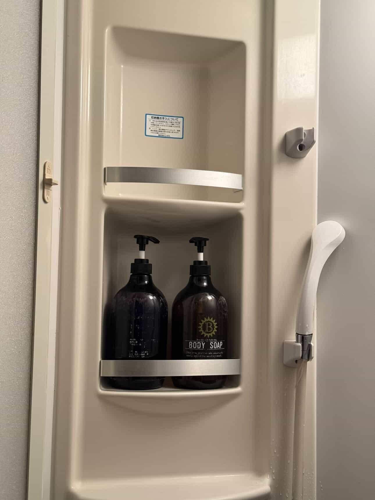 Soap and another bottle (label faded and hard to read) provided in the shared bathroom.