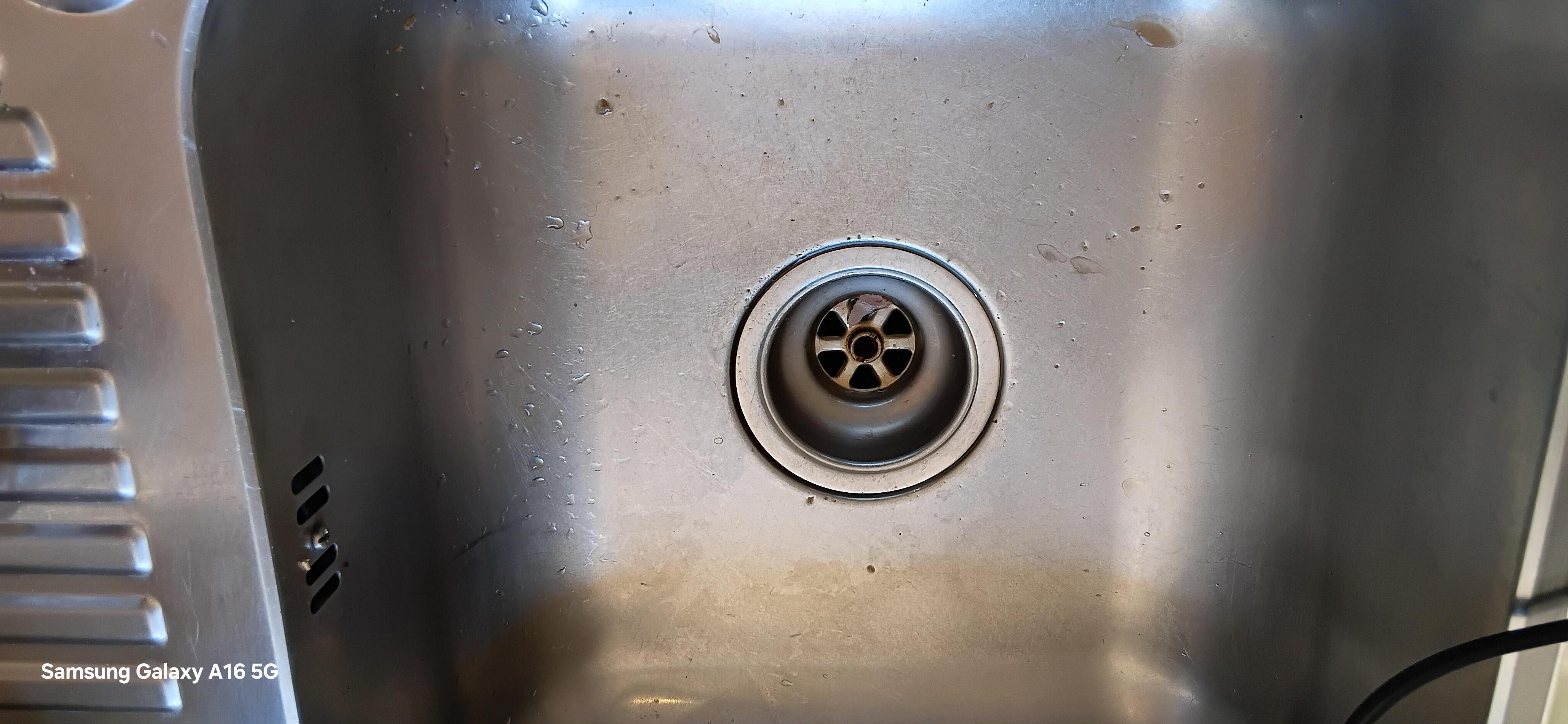 No kitchen sink plug or waste disposed.Stained aluminum bowl.