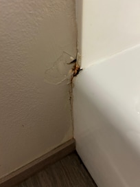 Deteriorating and rust where wall meets tub
