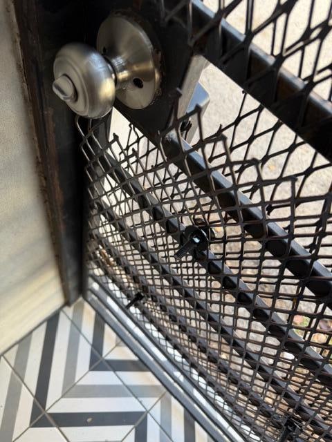 Fencing around the doorknob was still pried open.