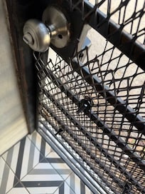 Fencing around the doorknob was still pried open.