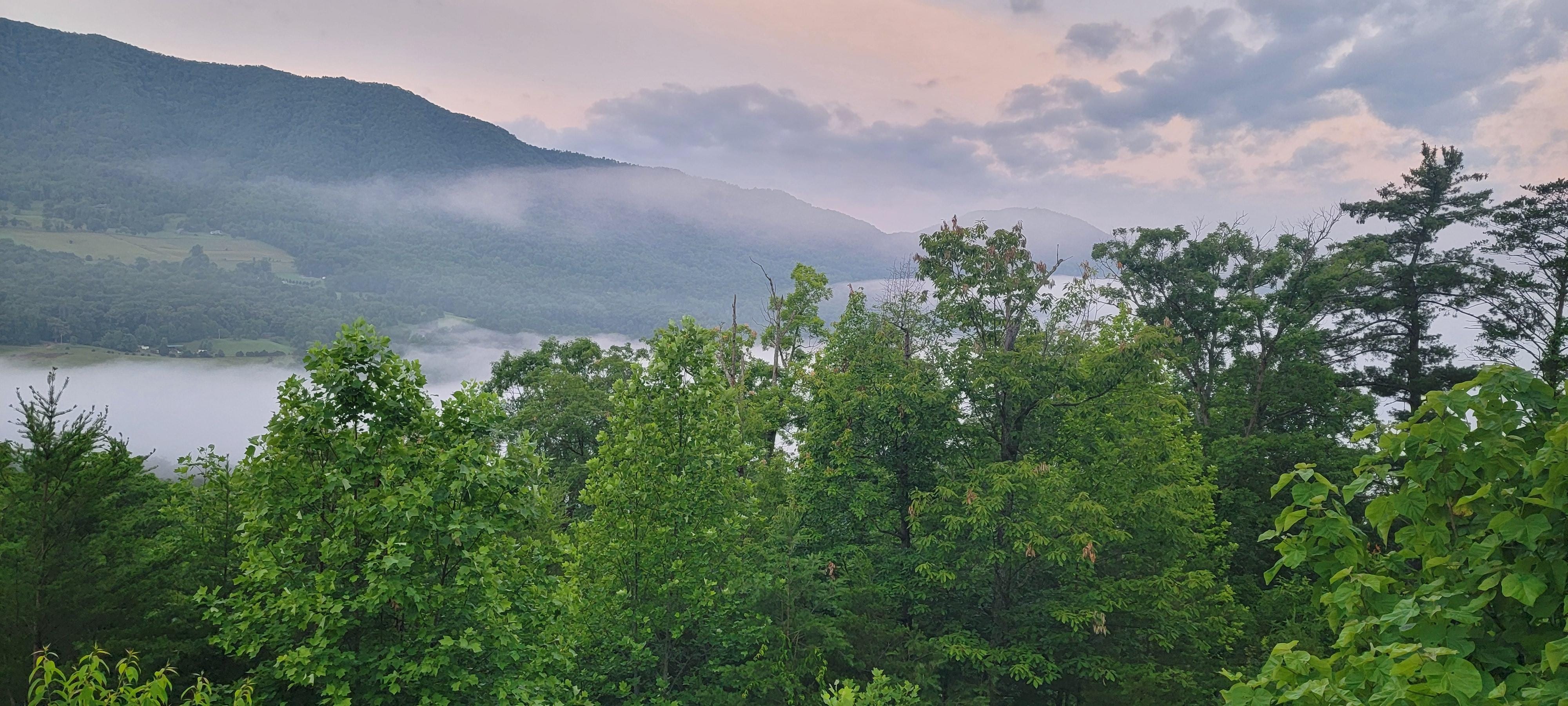 Sunrise with the clouds rolling into the valley. Kids lived hearing the distant sound of cows and rosters from a nearby farm once they stepped outside in the morning. 