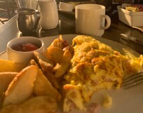 Deliciously big ham and cheese omelette with toast and potatoes included.