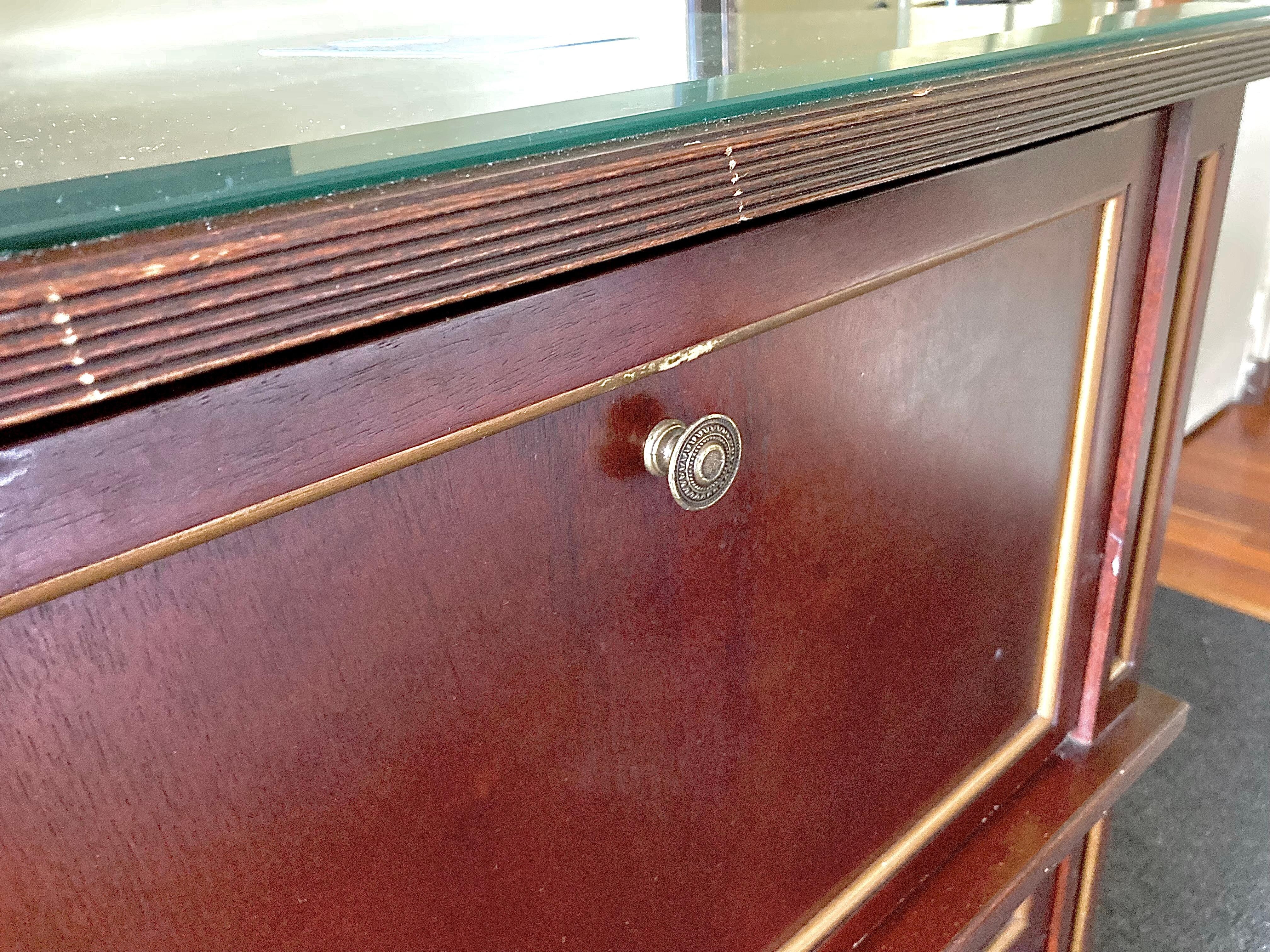 Ancient cabinet containing electrical outlets far in back and coffe maker/supplies.