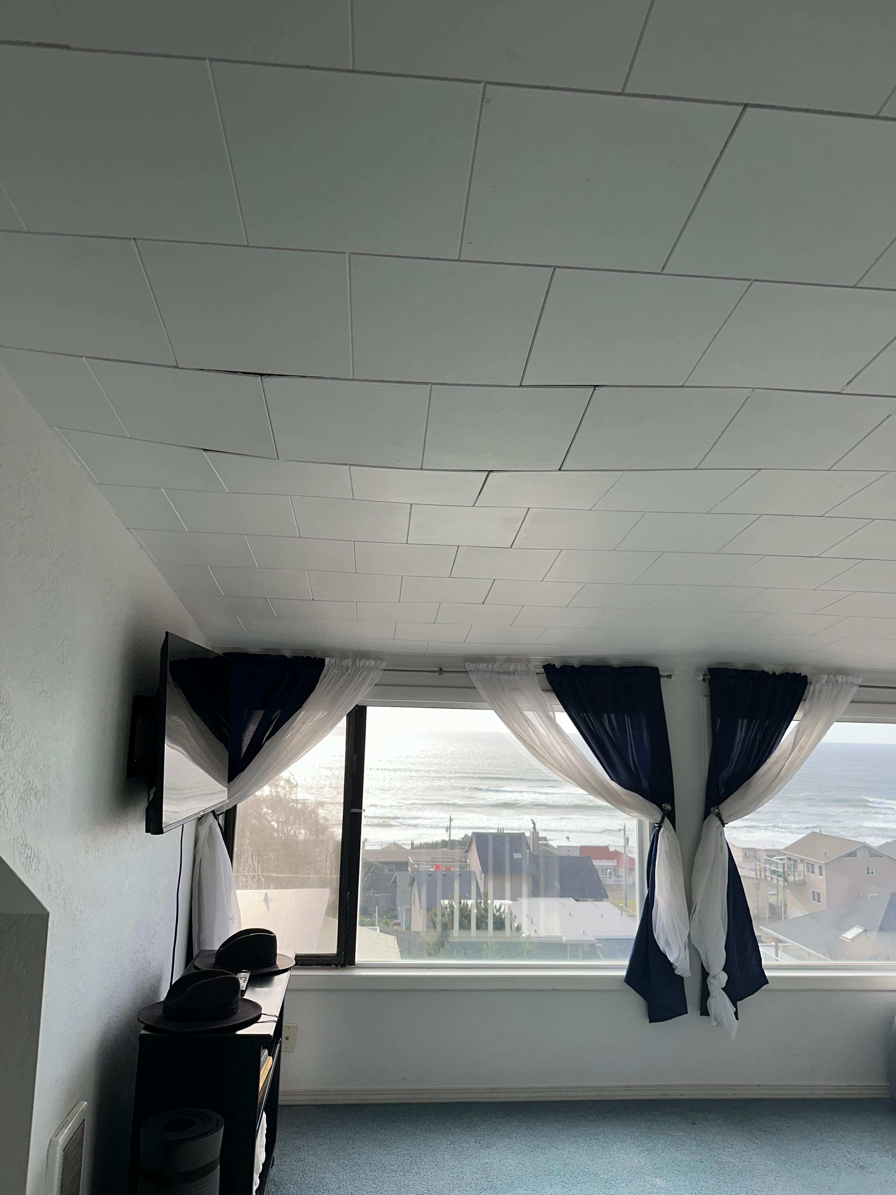 Upstairs ceiling tiles dropping from likely moisture damage