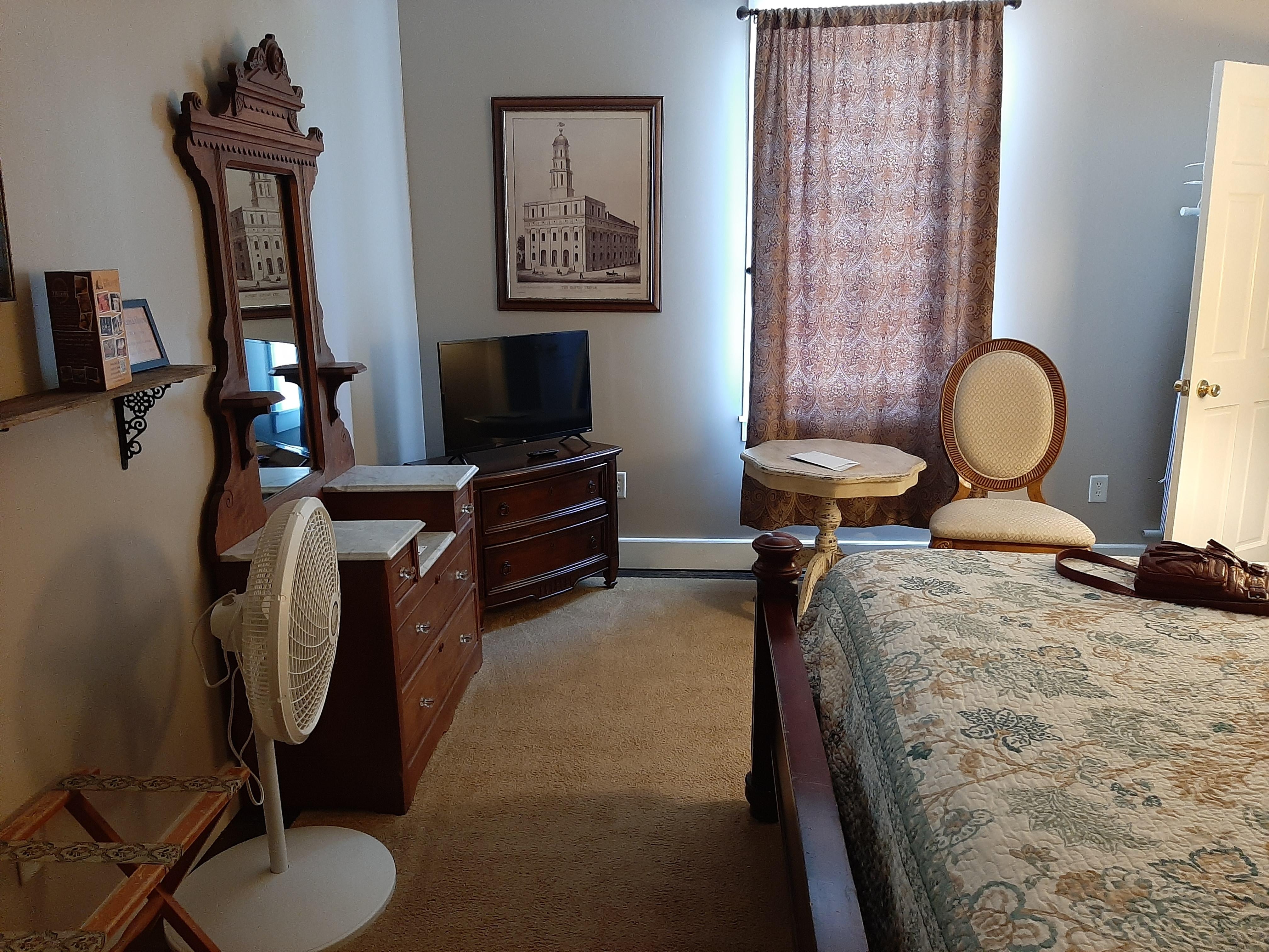 Our room had a king sized bed. Two windows, (one on the bedroom the other in the bathroom. pictures of Nauvoo, a chair and table. There was a microwave and mini fridge and hangers to hang clothes