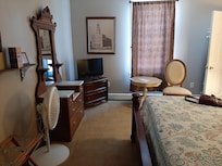 Our room had a king sized bed. Two windows, (one on the bedroom the other in the bathroom. pictures of Nauvoo, a chair and table. There was a microwave and mini fridge and hangers to hang clothes