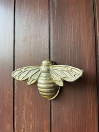 Bee door knocker on cottage