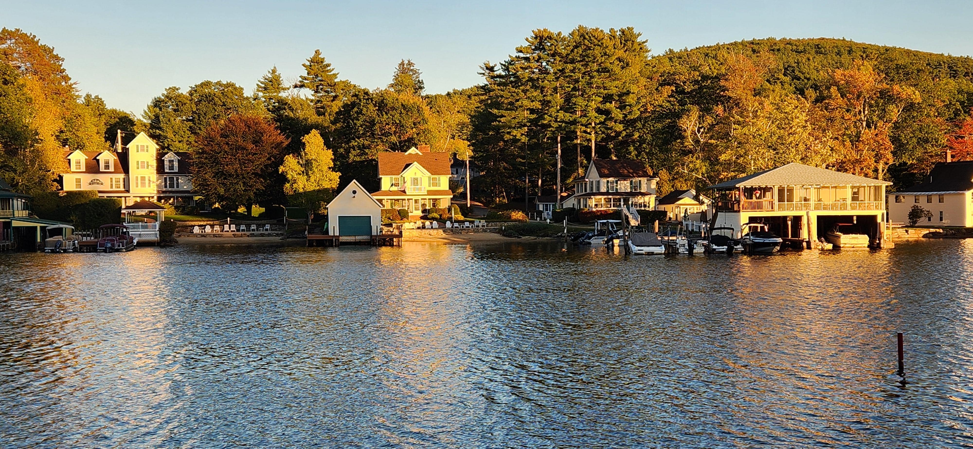 View of compound from across the lake. House is center-right, in front of covered boat.