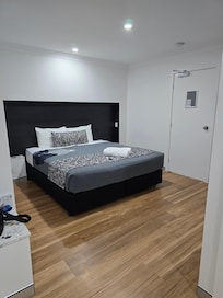 King bed, TV on wall