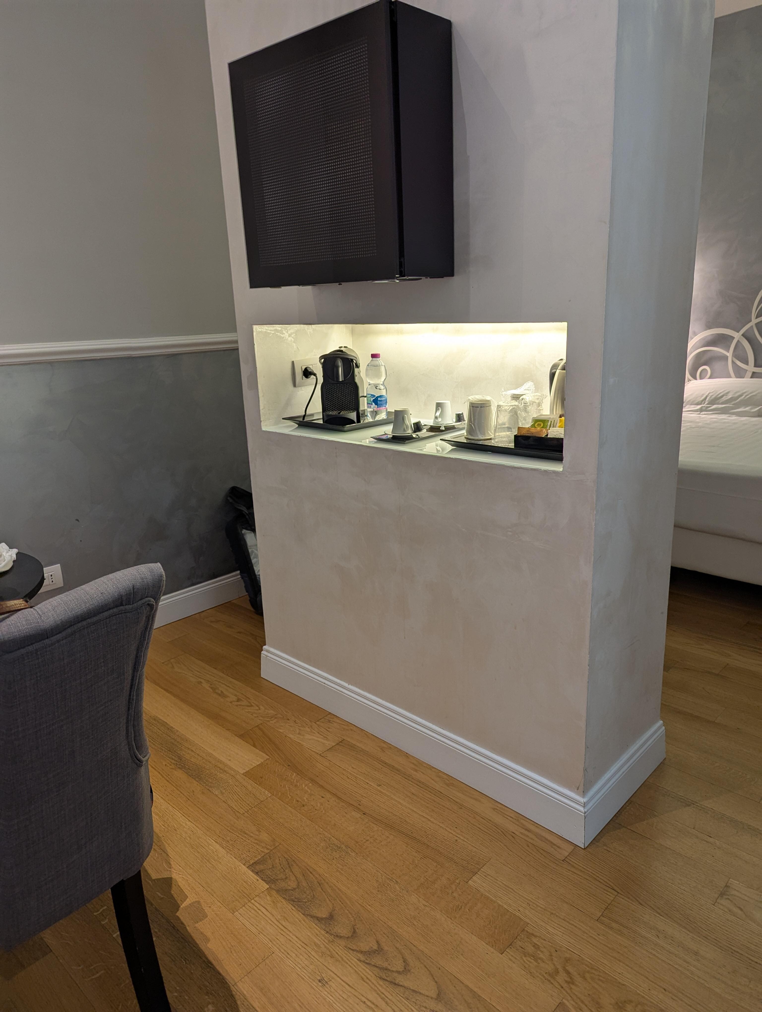 The black box on the wall is the fridge but half of the inside is taken up by the motor